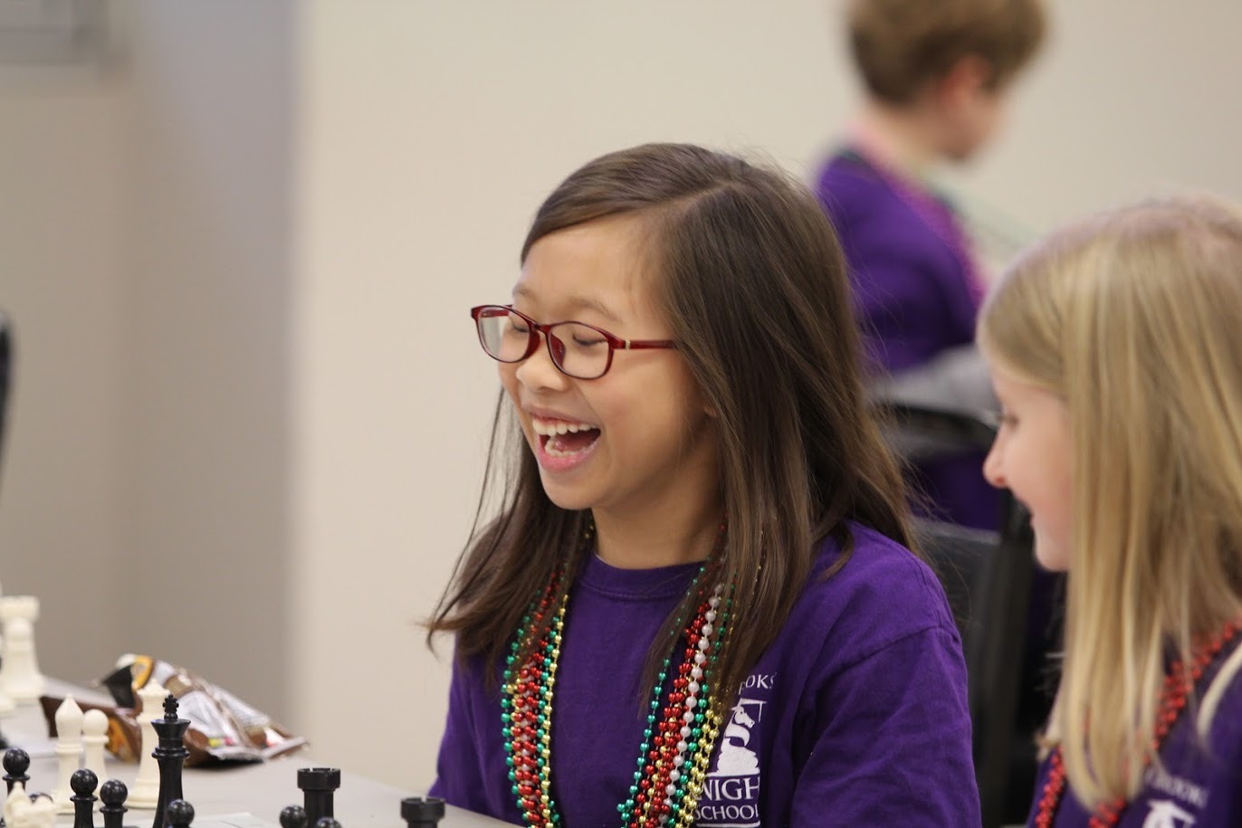 Young chess player deep in thought